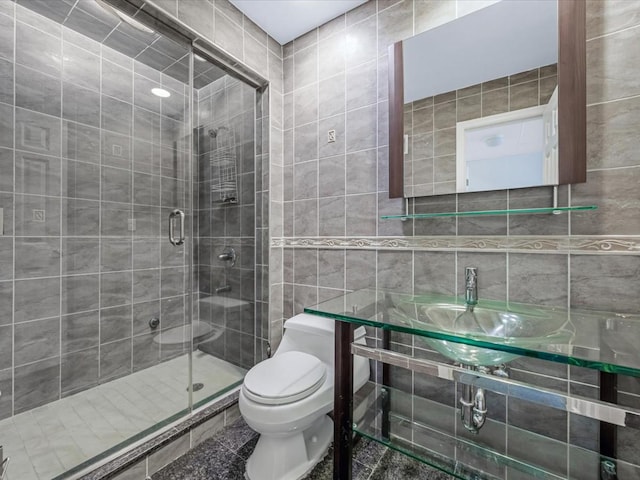 12 Pleasant Ave, Port Washington, NY 11050 - full bath with tile walls, a shower stall, toilet, and a sink