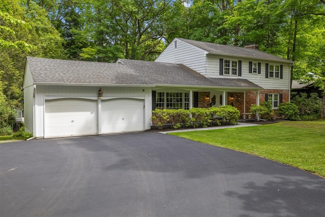 11 Carnelli Ct, Poughkeepsie, NY 12603 - view of front of house with a garage, driveway, a front yard, a chimney, and brick siding
