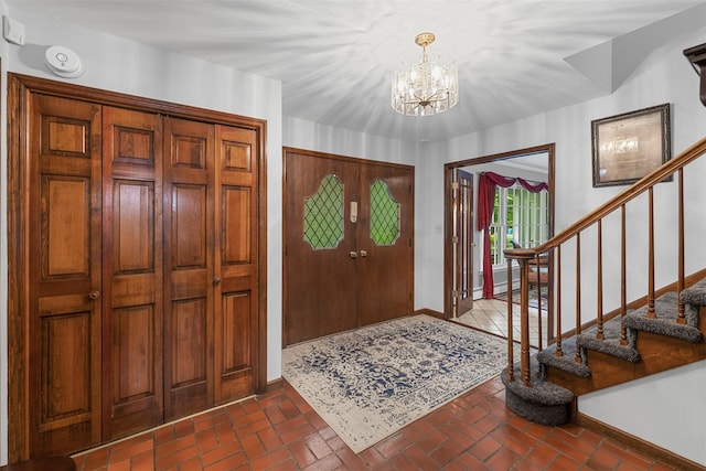 11 Carnelli Ct, Poughkeepsie, NY 12603 - entryway with baseboards, stairs, a chandelier, and brick floors