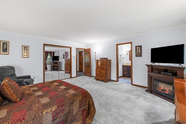 11 Carnelli Ct, Poughkeepsie, NY 12603 - bedroom with crown molding, light colored carpet, a glass covered fireplace, two closets, and ensuite bath