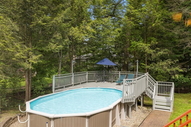 11 Carnelli Ct, Poughkeepsie, NY 12603 - view of swimming pool featuring stairway, a wooden deck, a hot tub, and view of scattered trees