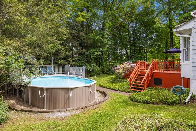 11 Carnelli Ct, Poughkeepsie, NY 12603 - swimming pool with a wooden deck, stairway, and view of wooded area