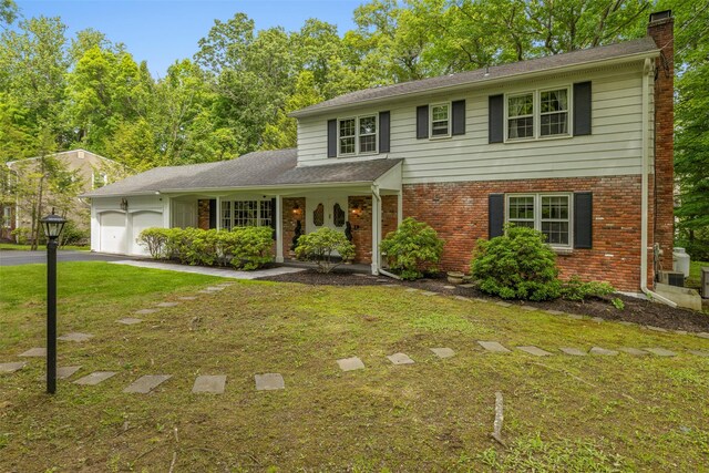 11 Carnelli Ct, Poughkeepsie, NY 12603 - view of front facade with a garage, brick siding, a chimney, and a front lawn