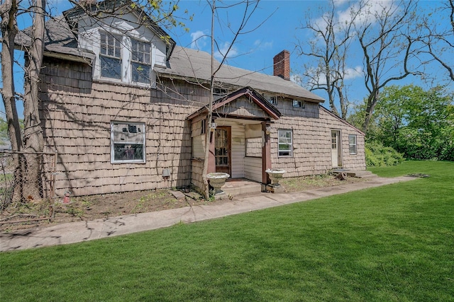 view of front of property with a chimney and a front yard