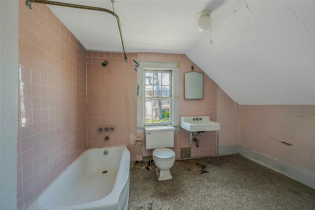 bathroom with vaulted ceiling, toilet, a sink, and shower / bathtub combination
