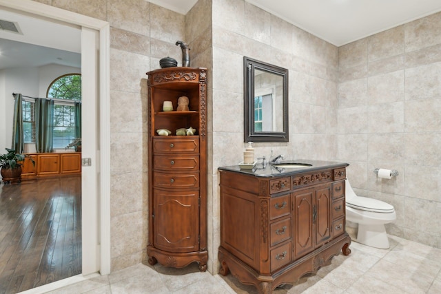 98 Beach Rd, Westhampton Beach, NY 11978 - bathroom with tile walls, vanity, and toilet