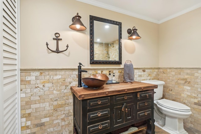 98 Beach Rd, Westhampton Beach, NY 11978 - bathroom with tile walls, toilet, a wainscoted wall, vanity, and ornamental molding