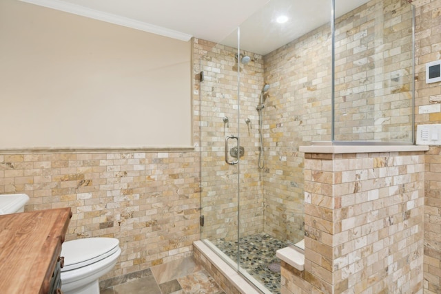 98 Beach Rd, Westhampton Beach, NY 11978 - full bath with a shower stall, toilet, tile walls, ornamental molding, and a wainscoted wall
