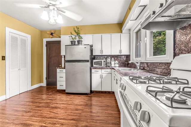 16 Rollhaus Pl, Port Chester, NY 10573 - kitchen with white appliances, under cabinet range hood, ceiling fan, a sink, and white cabinets