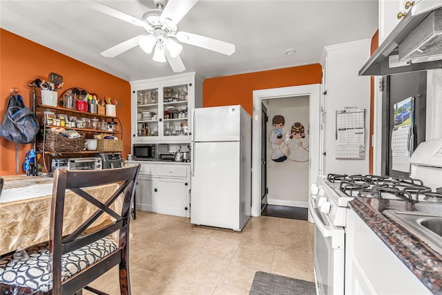 16 Rollhaus Pl, Port Chester, NY 10573 - kitchen with white appliances, under cabinet range hood, a ceiling fan, white cabinets, and dark countertops