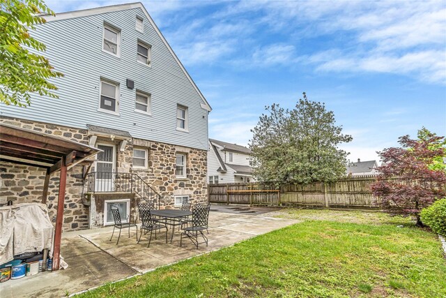 16 Rollhaus Pl, Port Chester, NY 10573 - rear view of house featuring stone siding and a patio