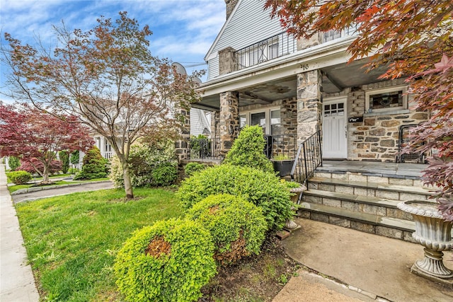16 Rollhaus Pl, Port Chester, NY 10573 - doorway to property with covered porch, stone siding, and a balcony