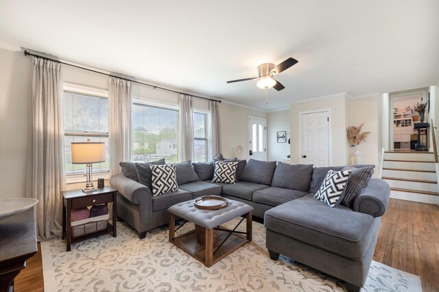 22 Willow Pl, Middletown, NY 10940 - living room featuring light wood-type flooring, ornamental molding, a ceiling fan, and stairs