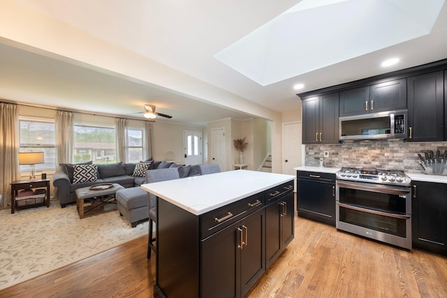 22 Willow Pl, Middletown, NY 10940 - kitchen with stainless steel appliances, light countertops, light wood-style flooring, backsplash, and recessed lighting