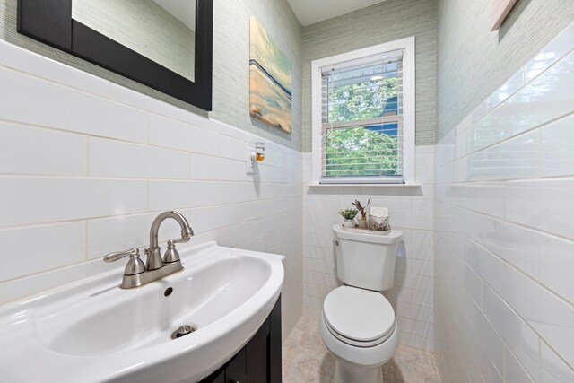 22 Willow Pl, Middletown, NY 10940 - half bath with tile walls, toilet, vanity, and a wainscoted wall