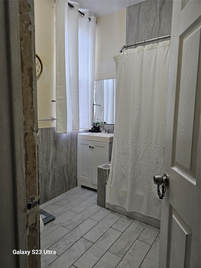 215 S 1st Ave, Mount Vernon, NY 10550 - full bathroom with vanity, marble look tile flooring, and shower / bath combo with shower curtain
