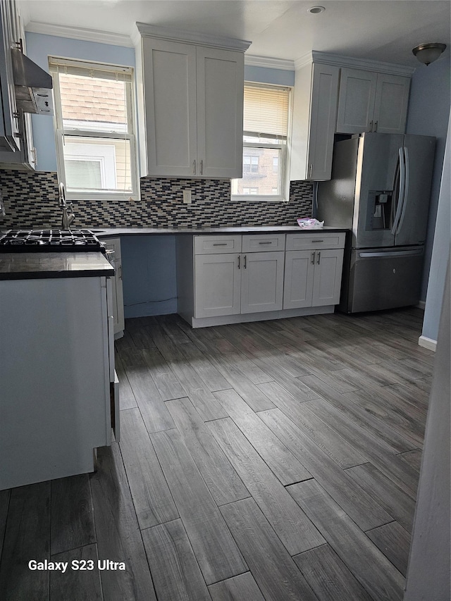 215 S 1st Ave, Mount Vernon, NY 10550 - kitchen with stainless steel fridge with ice dispenser, crown molding, wood finished floors, tasteful backsplash, and exhaust hood
