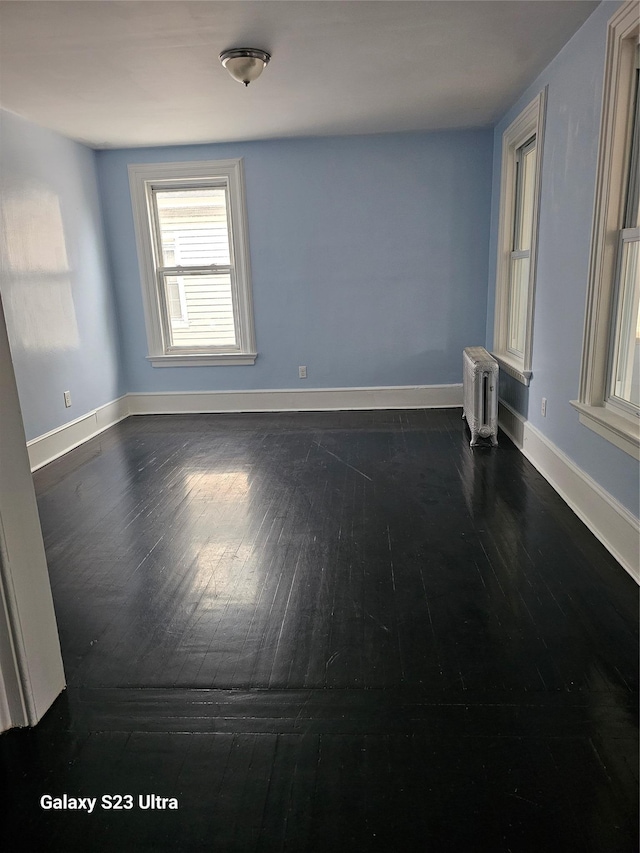 215 S 1st Ave, Mount Vernon, NY 10550 - spare room featuring radiator heating unit, dark wood-style floors, and baseboards