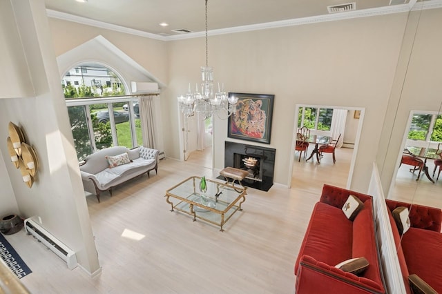 2525 Beverly Rd, Merrick, NY 11566 - living area with baseboard heating, plenty of natural light, a chandelier, a high ceiling, and wood finished floors