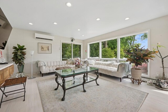 2525 Beverly Rd, Merrick, NY 11566 - living room featuring an AC wall unit, recessed lighting, light wood-style flooring, and baseboard heating