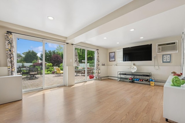 2525 Beverly Rd, Merrick, NY 11566 - living area featuring a wall unit AC, wood finished floors, recessed lighting, and a baseboard heating unit