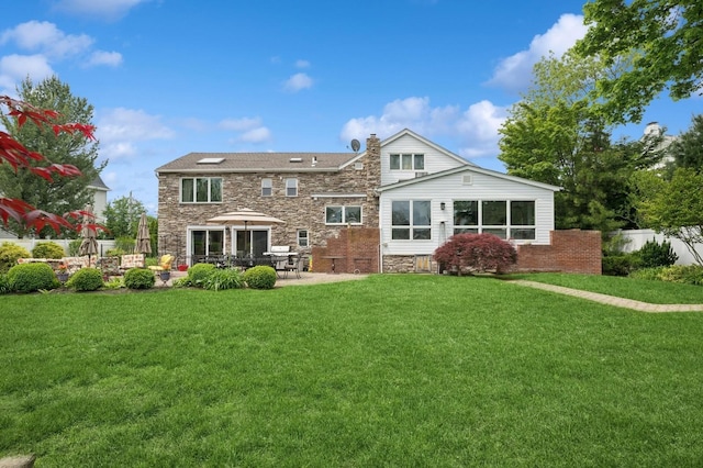 2525 Beverly Rd, Merrick, NY 11566 - back of property with stone siding, a chimney, and a patio
