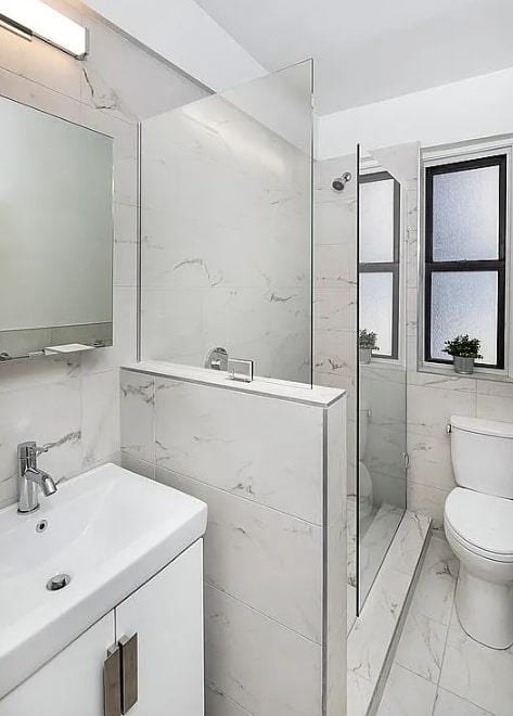 3000 Valentine Ave Unit 2E, Bronx, NY 10458 - full bath with tile walls, marble finish flooring, toilet, a shower stall, and vanity