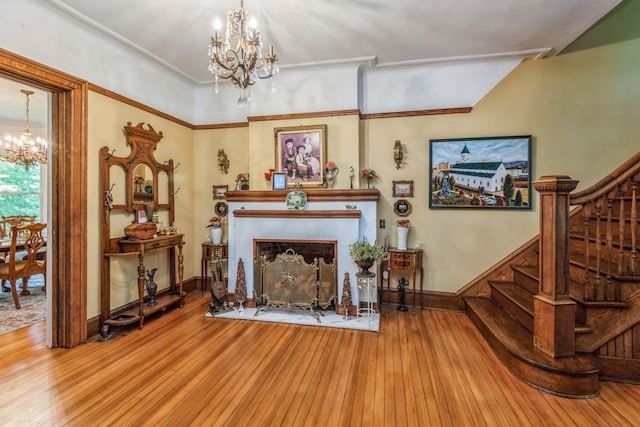 110 Red Spring Ln, Glen Cove, NY 11542 - living room with a chandelier, stairs, wood-type flooring, baseboards, and a fireplace with raised hearth