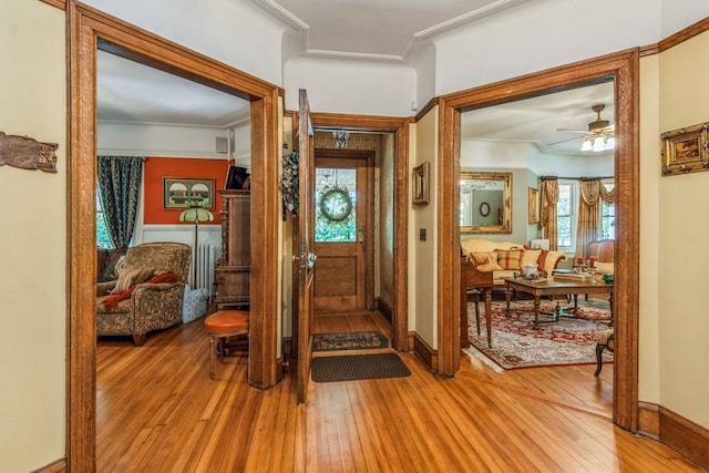 110 Red Spring Ln, Glen Cove, NY 11542 - entrance foyer featuring light wood-type flooring, ceiling fan, ornamental molding, and baseboards