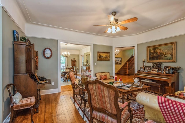 110 Red Spring Ln, Glen Cove, NY 11542 - dining room with hardwood / wood-style floors, stairway, ceiling fan, a chandelier, and baseboards