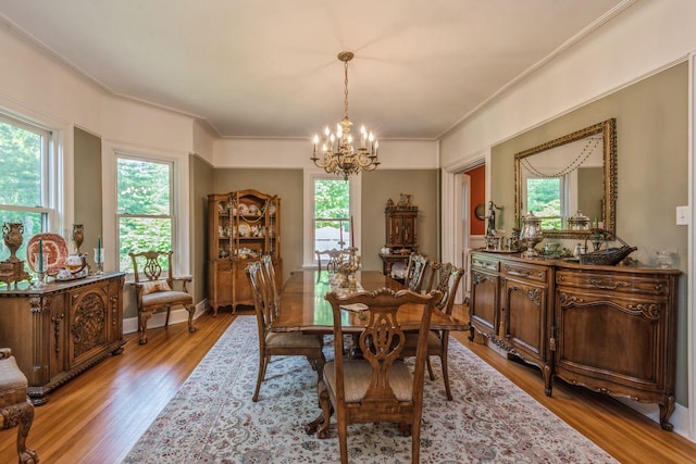 110 Red Spring Ln, Glen Cove, NY 11542 - dining area with a chandelier, wood finished floors, and crown molding