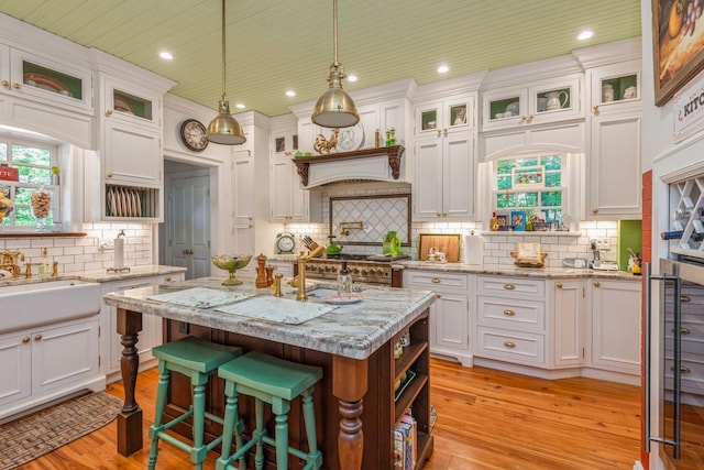 110 Red Spring Ln, Glen Cove, NY 11542 - kitchen with white cabinetry, decorative backsplash, a sink, recessed lighting, and hanging light fixtures