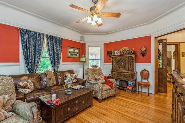 110 Red Spring Ln, Glen Cove, NY 11542 - living room featuring a wainscoted wall, a ceiling fan, light wood-type flooring, and radiator heating unit