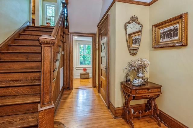 110 Red Spring Ln, Glen Cove, NY 11542 - foyer entrance with light wood finished floors, stairs, baseboards, and ornamental molding