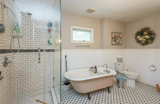 110 Red Spring Ln, Glen Cove, NY 11542 - full bathroom featuring a shower stall, a soaking tub, a wainscoted wall, and toilet
