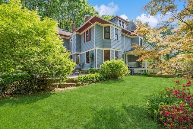 110 Red Spring Ln, Glen Cove, NY 11542 - rear view of house with a chimney and a lawn
