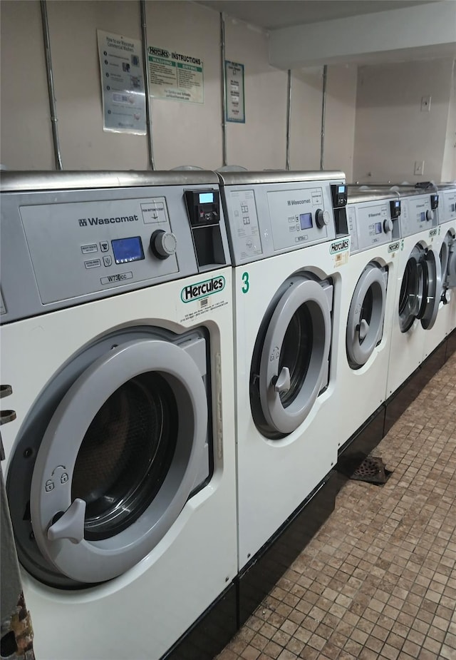 communal laundry room with independent washer and dryer