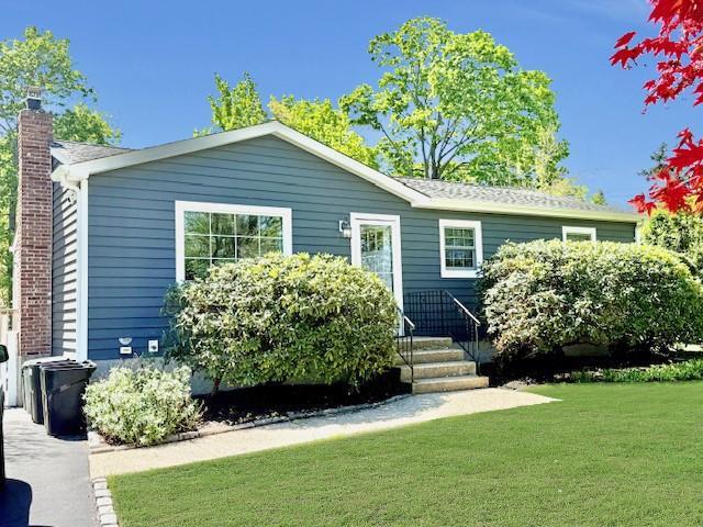 18 Cherry Ln, Port Jefferson Station, NY 11776 - view of front of house featuring a chimney and a front yard