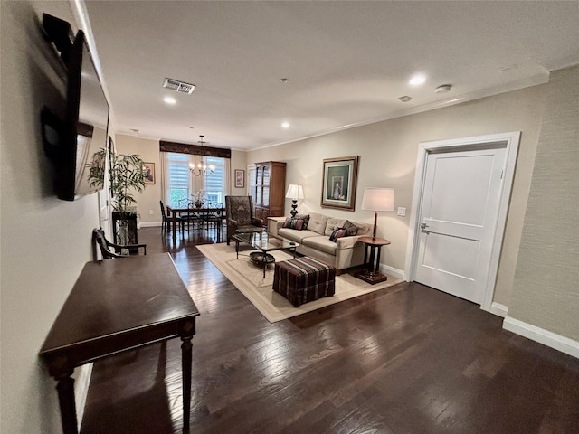 living room with a chandelier, wood finished floors, baseboards, recessed lighting, and crown molding