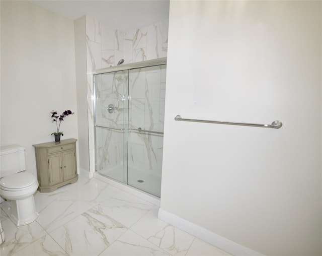 full bathroom featuring toilet, a marble finish shower, marble finish flooring, and baseboards