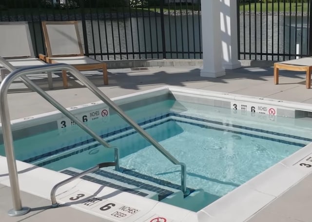 view of pool featuring fence