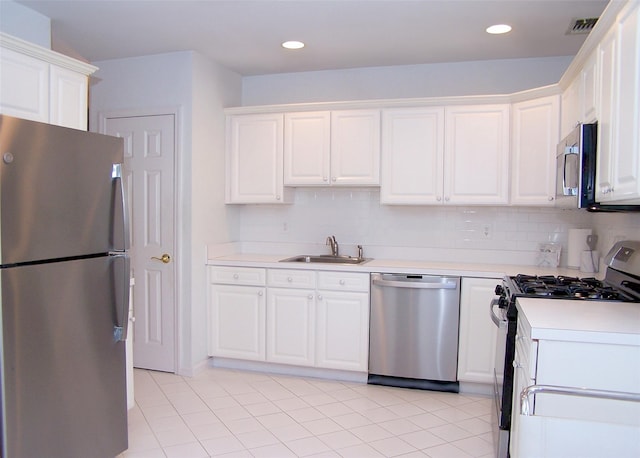 29 Madison Cir, Middle Island, NY 11953 - kitchen featuring stainless steel appliances, a sink, white cabinets, light countertops, and light tile patterned floors