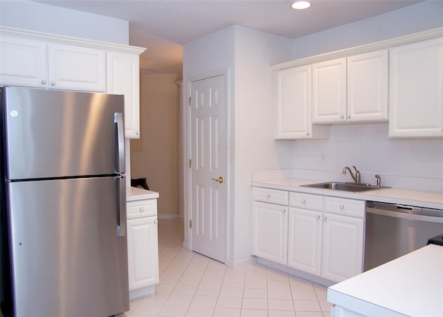 29 Madison Cir, Middle Island, NY 11953 - kitchen with appliances with stainless steel finishes, a sink, light tile patterned floors, light countertops, and white cabinetry