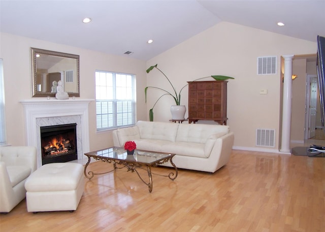 29 Madison Cir, Middle Island, NY 11953 - living room featuring light wood-style floors, lofted ceiling, a high end fireplace, recessed lighting, and baseboards