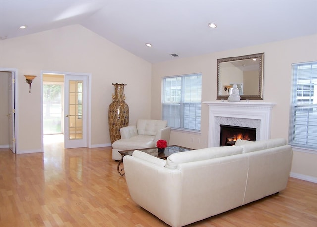 29 Madison Cir, Middle Island, NY 11953 - living room featuring light wood-style floors, healthy amount of natural light, a high end fireplace, vaulted ceiling, and recessed lighting