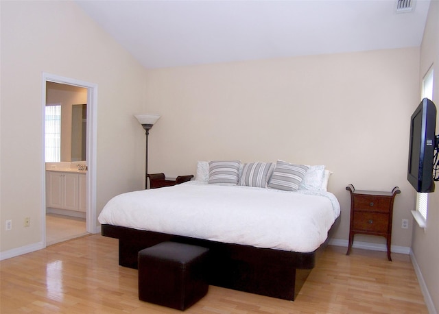 29 Madison Cir, Middle Island, NY 11953 - bedroom with light wood-type flooring, baseboards, lofted ceiling, and ensuite bathroom