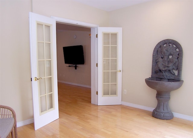 29 Madison Cir, Middle Island, NY 11953 - hall featuring french doors, light wood-style flooring, and baseboards