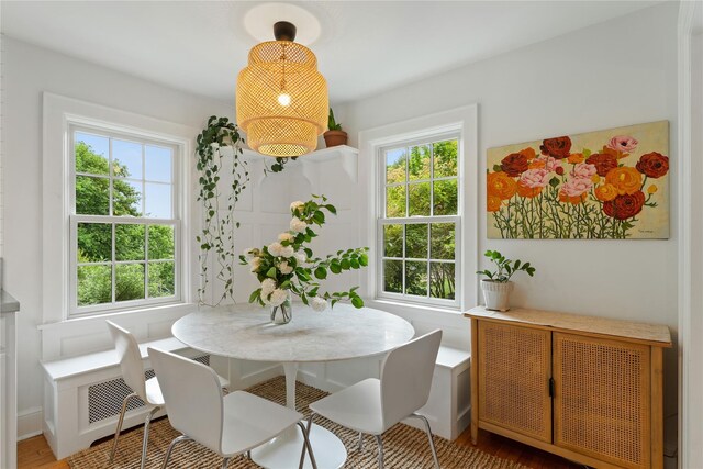 dining area featuring plenty of natural light and wood finished floors