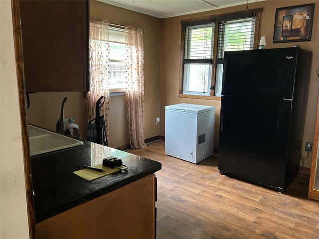 27 First St, Godeffroy, NY 12729 - kitchen with freestanding refrigerator, fridge, light wood-style flooring, ornamental molding, and dark countertops