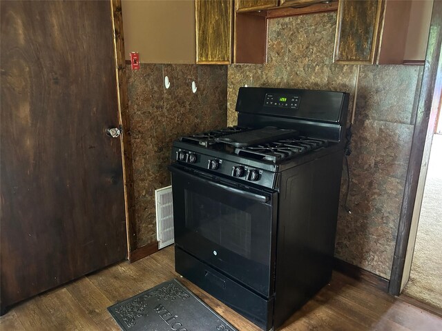 27 First St, Godeffroy, NY 12729 - kitchen with black range with gas cooktop and wood finished floors